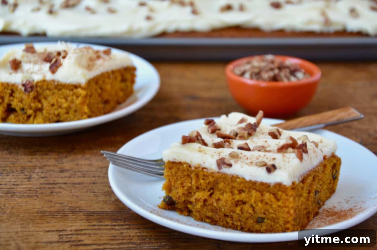 Pumpkin bars with cream cheese frosting on plates.