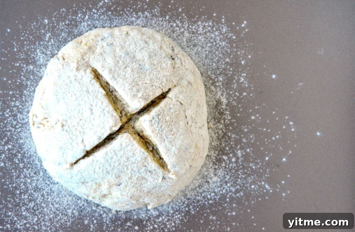 Unbaked soda bread with a deep "X" cut into the center.