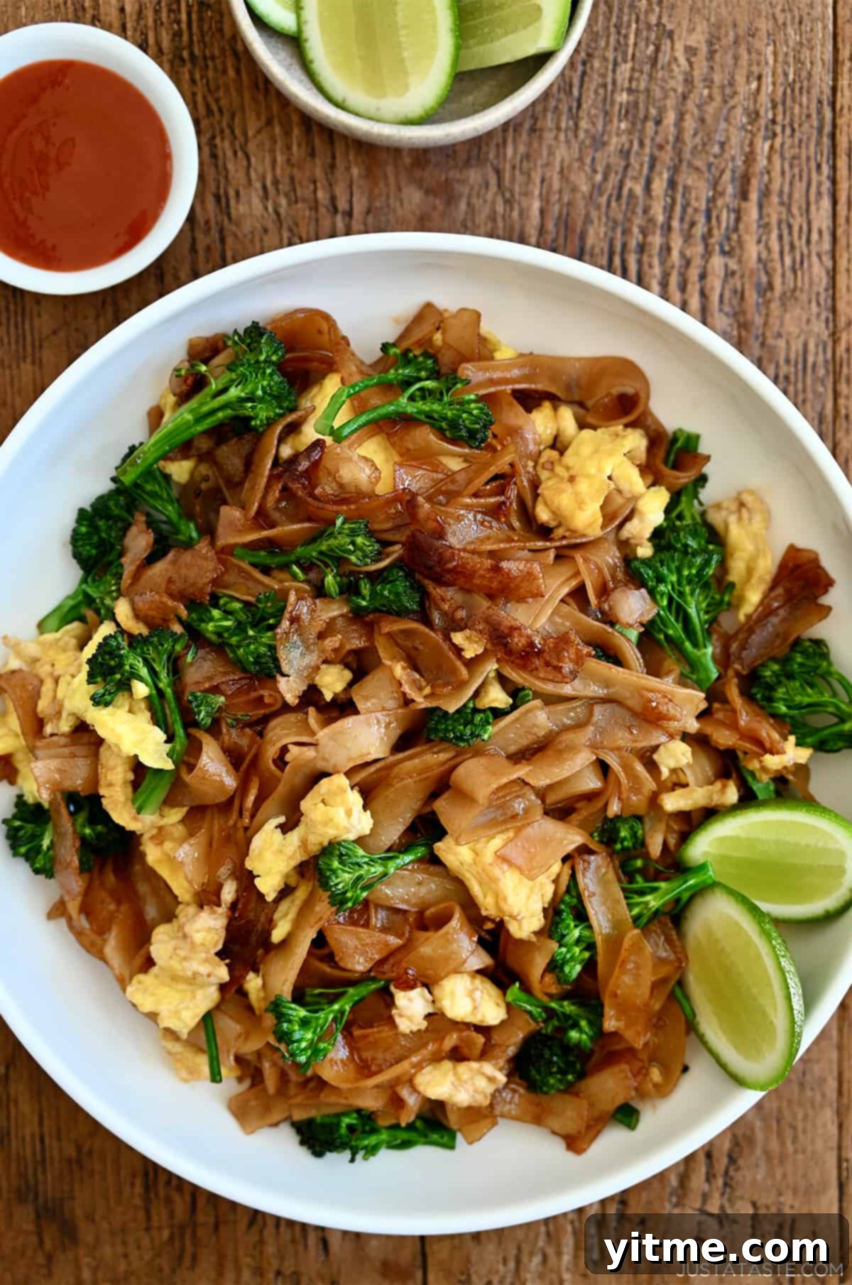 Delicious Pad See Ew served with lime wedges