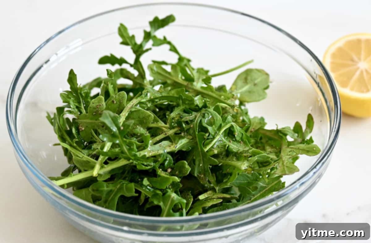 Fresh arugula dressed with lemon juice, salt, and pepper