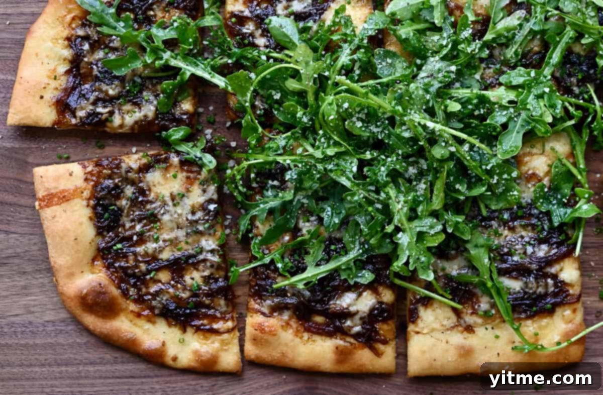 French Onion Pizza topped with arugula