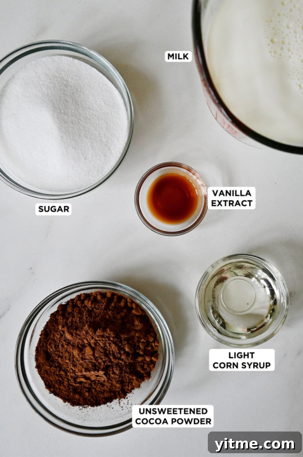 The six essential ingredients for homemade fudge pops: granulated sugar, milk, light corn syrup, vanilla extract, a pinch of salt, and unsweetened cocoa powder.