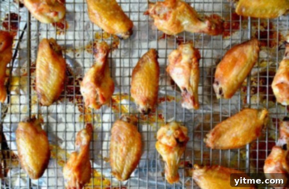 Zesty Orange Baked Chicken Wings 3 Baked chicken wings on a wire rack.