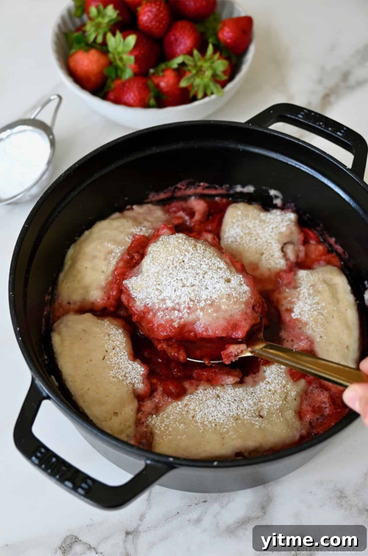 Strawberry sauce topped with fluffy dumplings