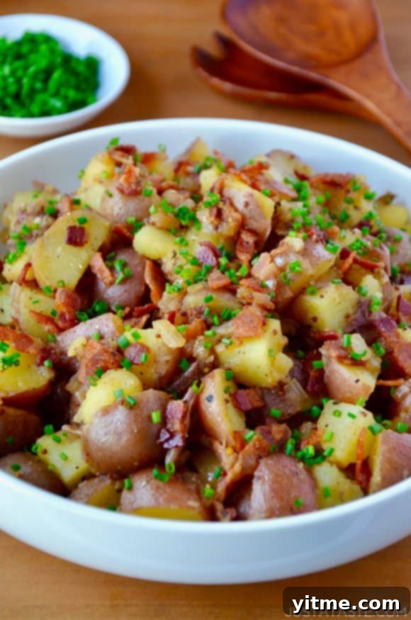 White bowl with Potato Salad with Warm Bacon Dressing