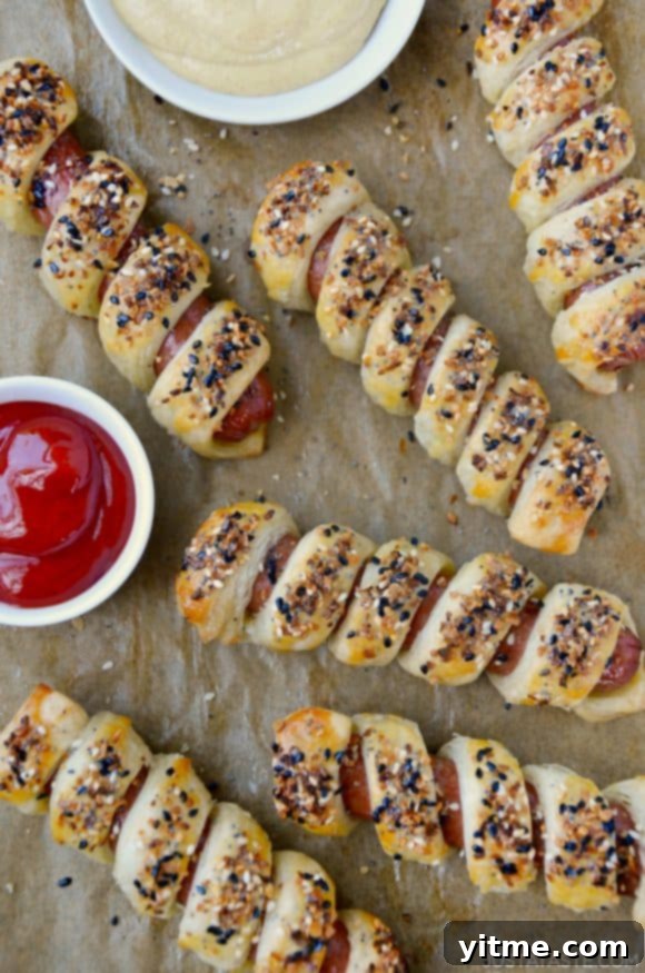 Everything Puff Pastry Pigs In a Blanket on parchment paper