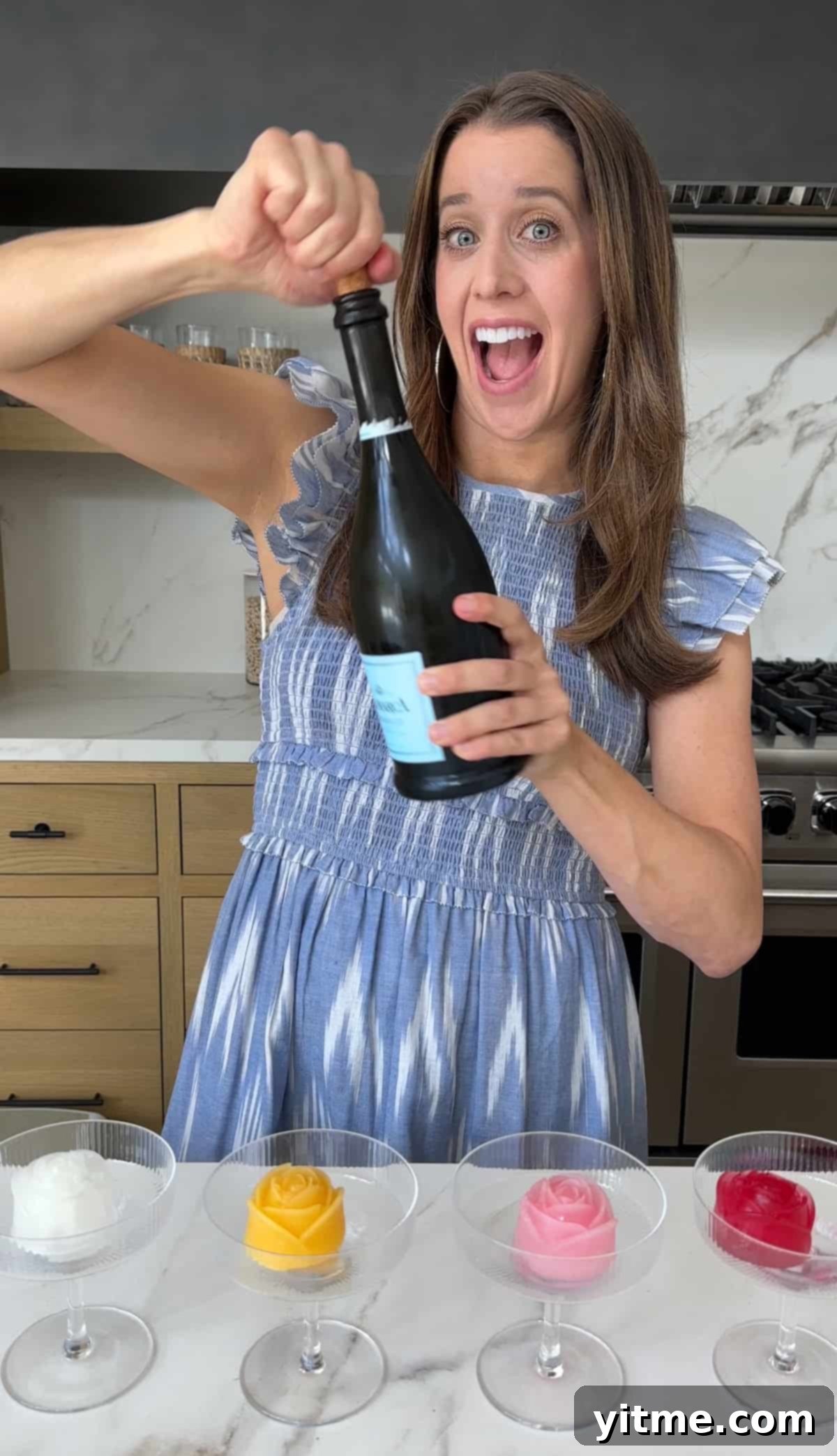 Kelly Senyei opens a bottle of champagne for mimosas.