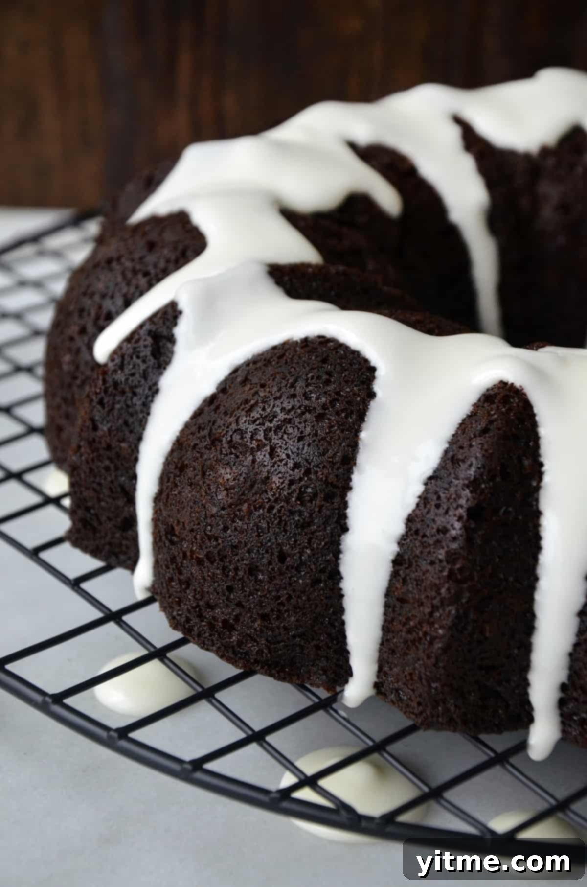 Chocolate gingerbread bundt cake drizzled with white glaze