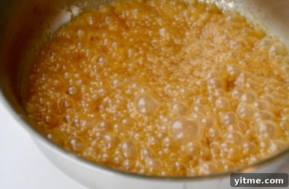 Easy homemade butterscotch sauce simmering in a saucepan