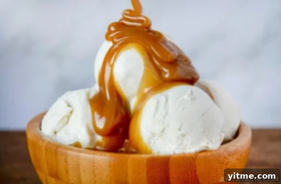 The best homemade butterscotch sauce generously spooned over scoops of vanilla ice cream