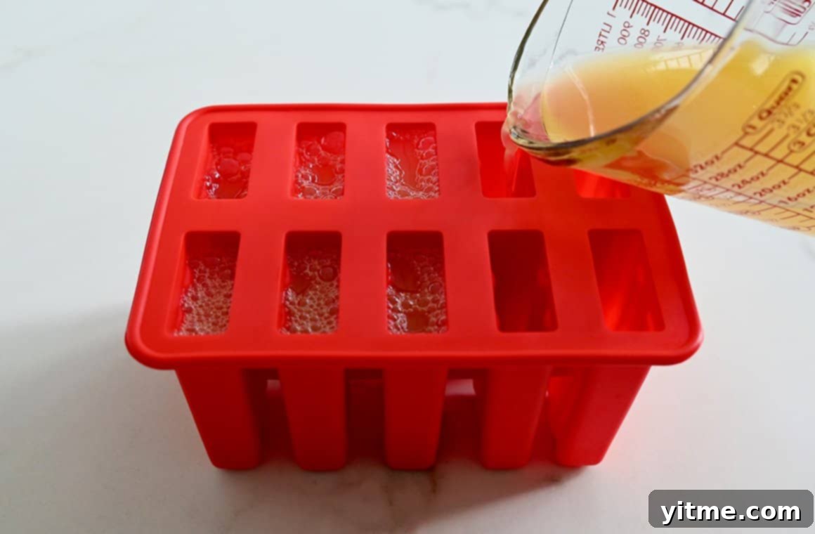 Cocktail mixture being poured into a silicone mold