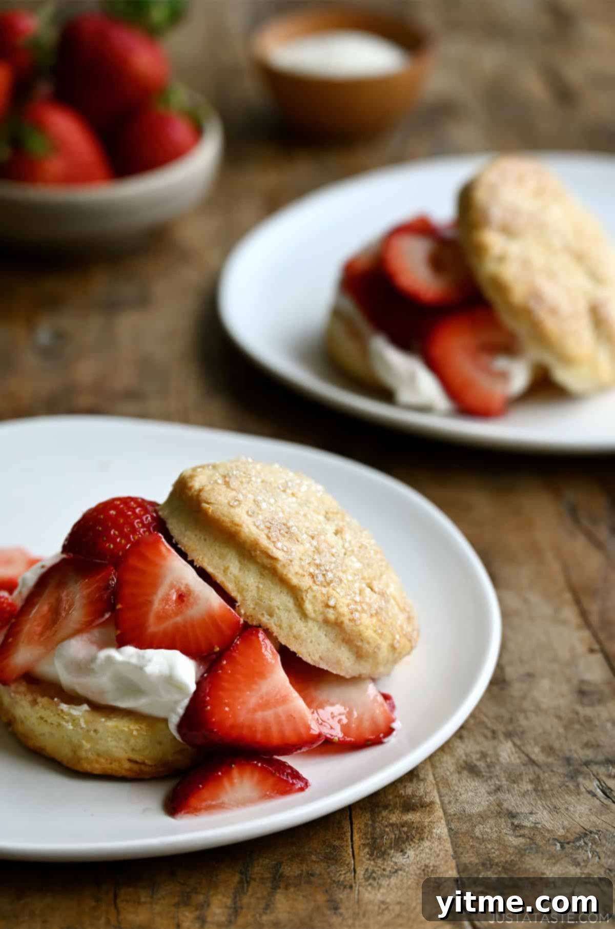 Quick Strawberry Shortcake 10 Two strawberry shortcakes on a white plate with a fork.