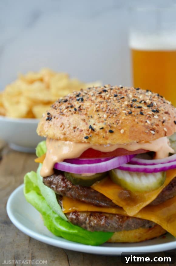 Juicy cheeseburger served with crispy chips and a refreshing beer