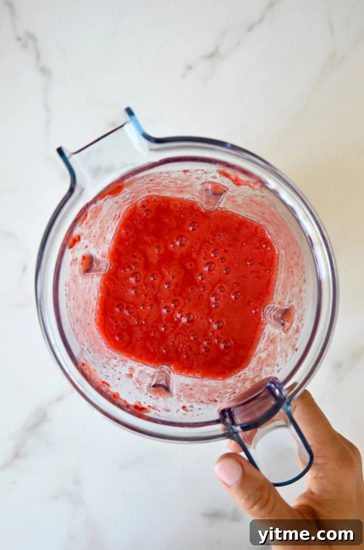 Strawberry purée in a blender.