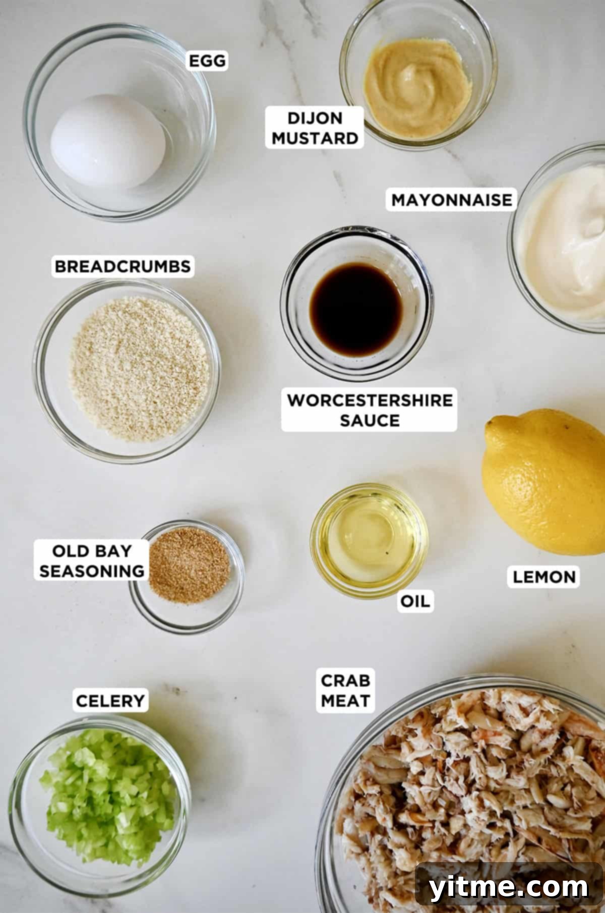 Ingredients for making crab cakes in glass bowls.