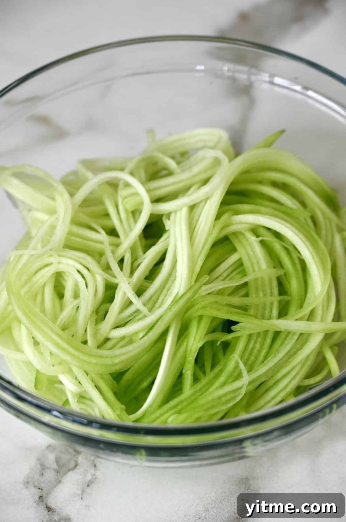Cucumber matchsticks in a glass bowl.