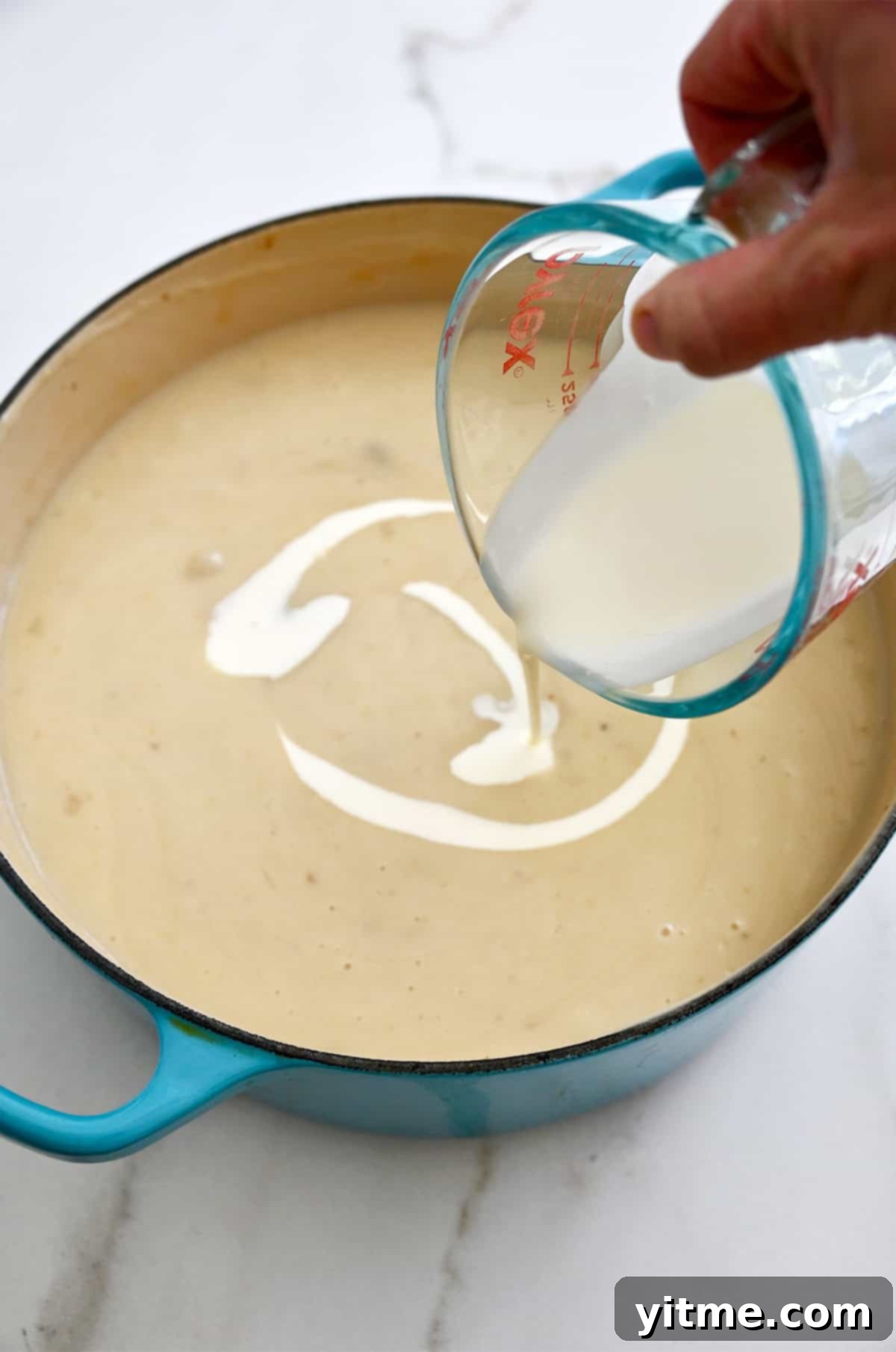 Creamy Potato Soup with Crispy Bacon and Cheddar 11 Stirring in heavy cream.