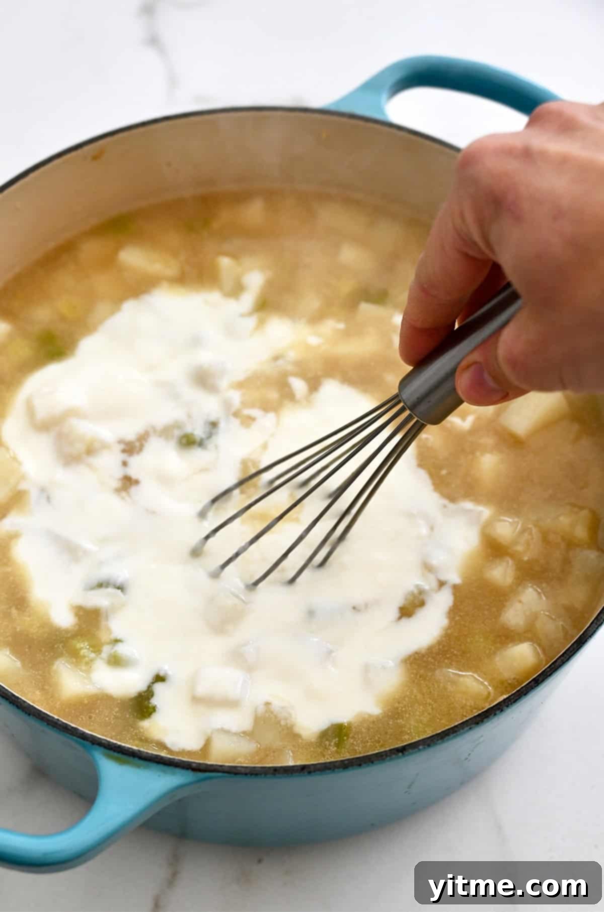 Creamy Potato Soup with Crispy Bacon and Cheddar 9 Whisking the roux into the potato soup.