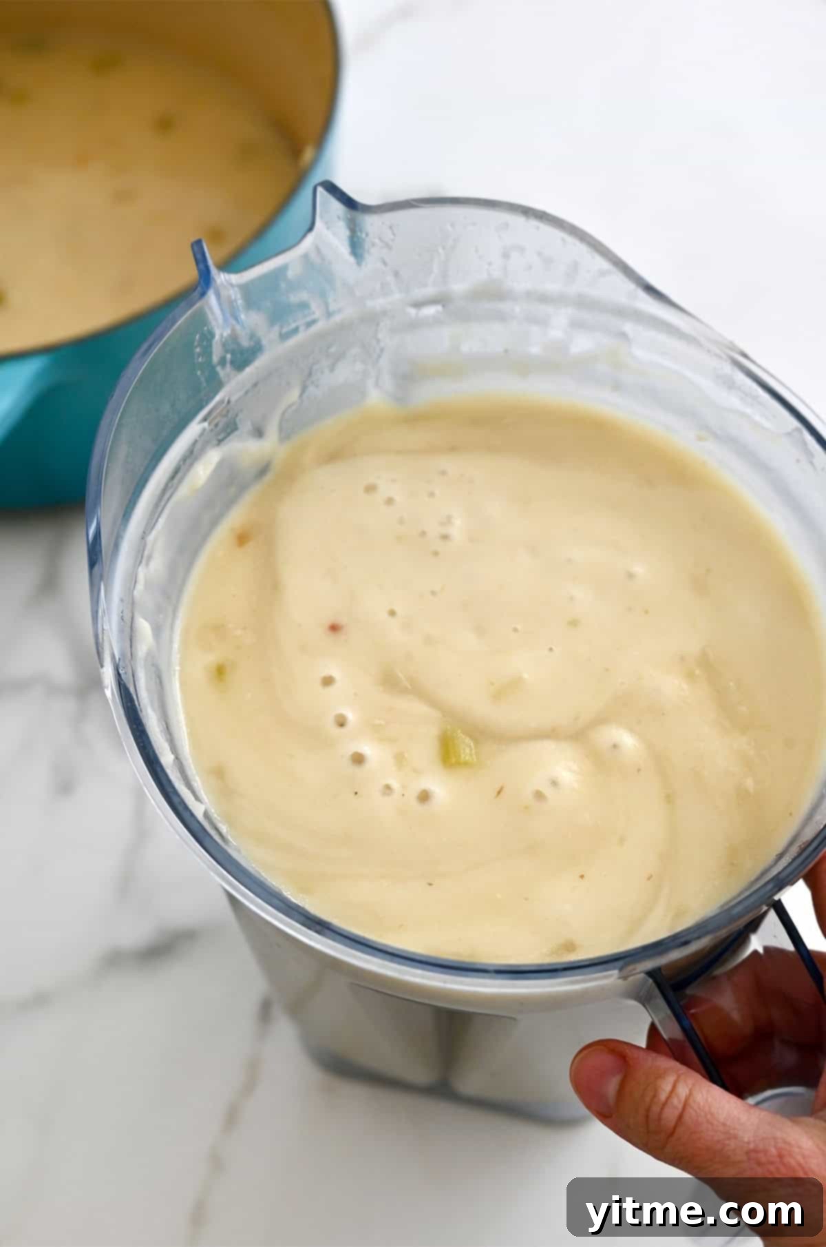 Creamy Potato Soup with Crispy Bacon and Cheddar 10 Pureeing the potato soup in a blender.