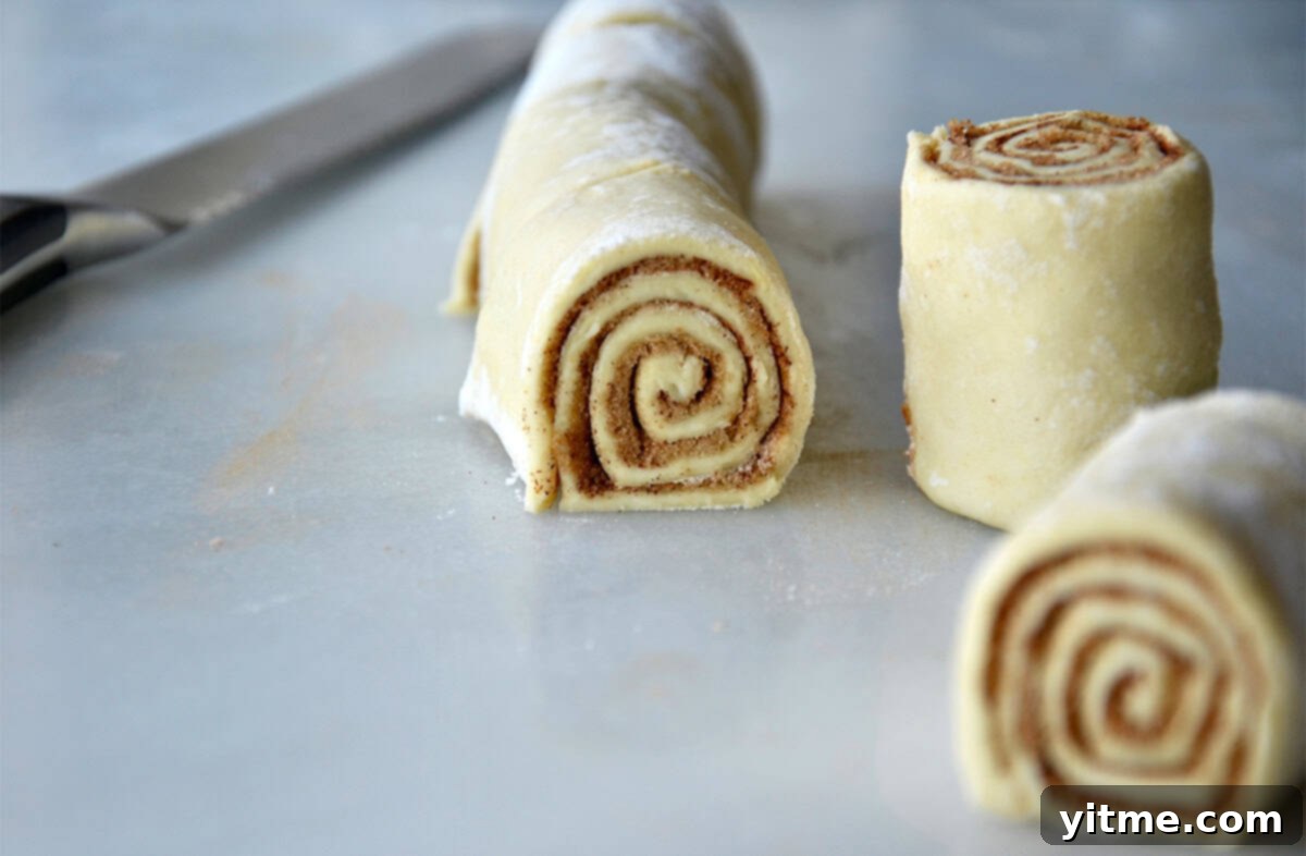Cut cinnamon roll dough.