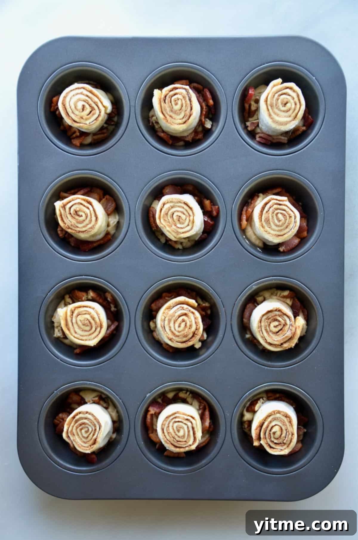 Cinnamon rolls in a muffin tin.