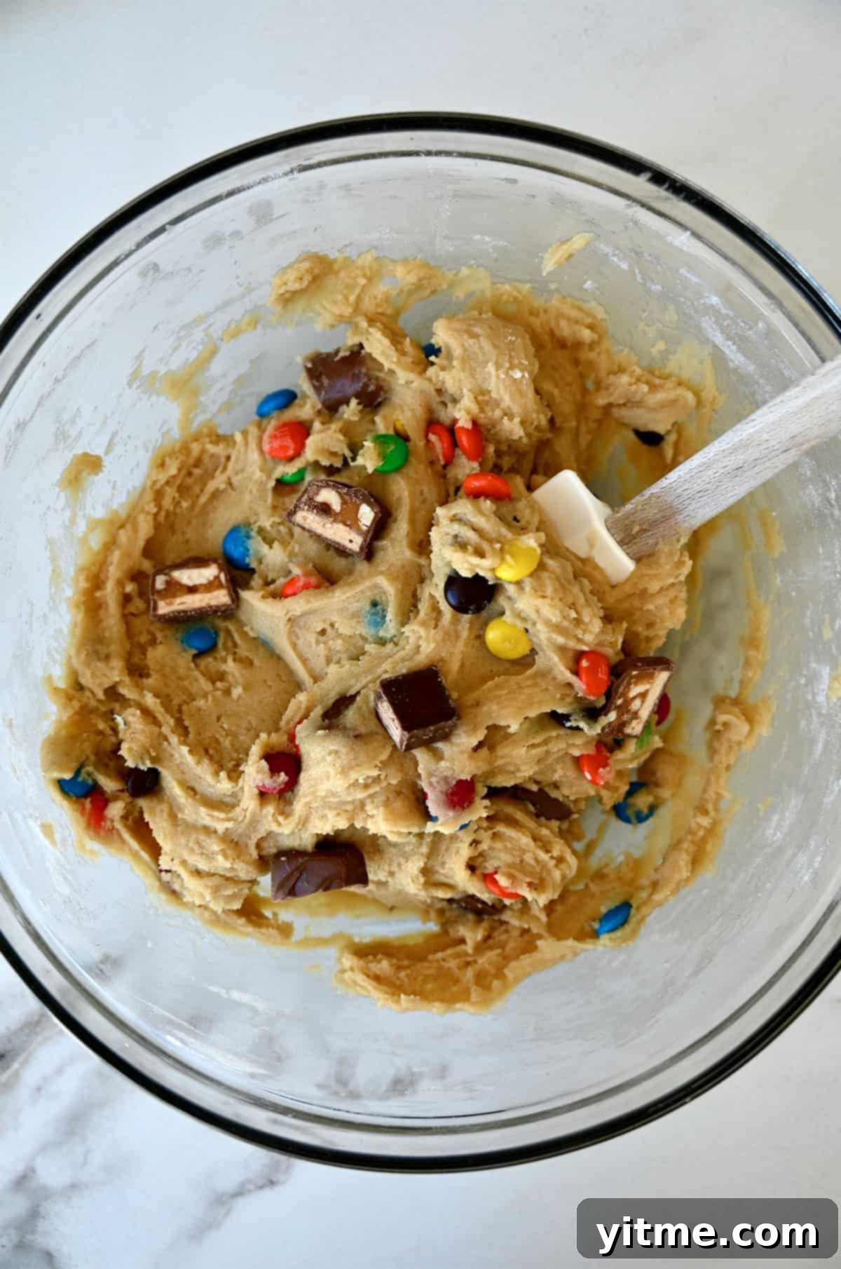 Leftover Halloween candy blondie batter in a bowl.