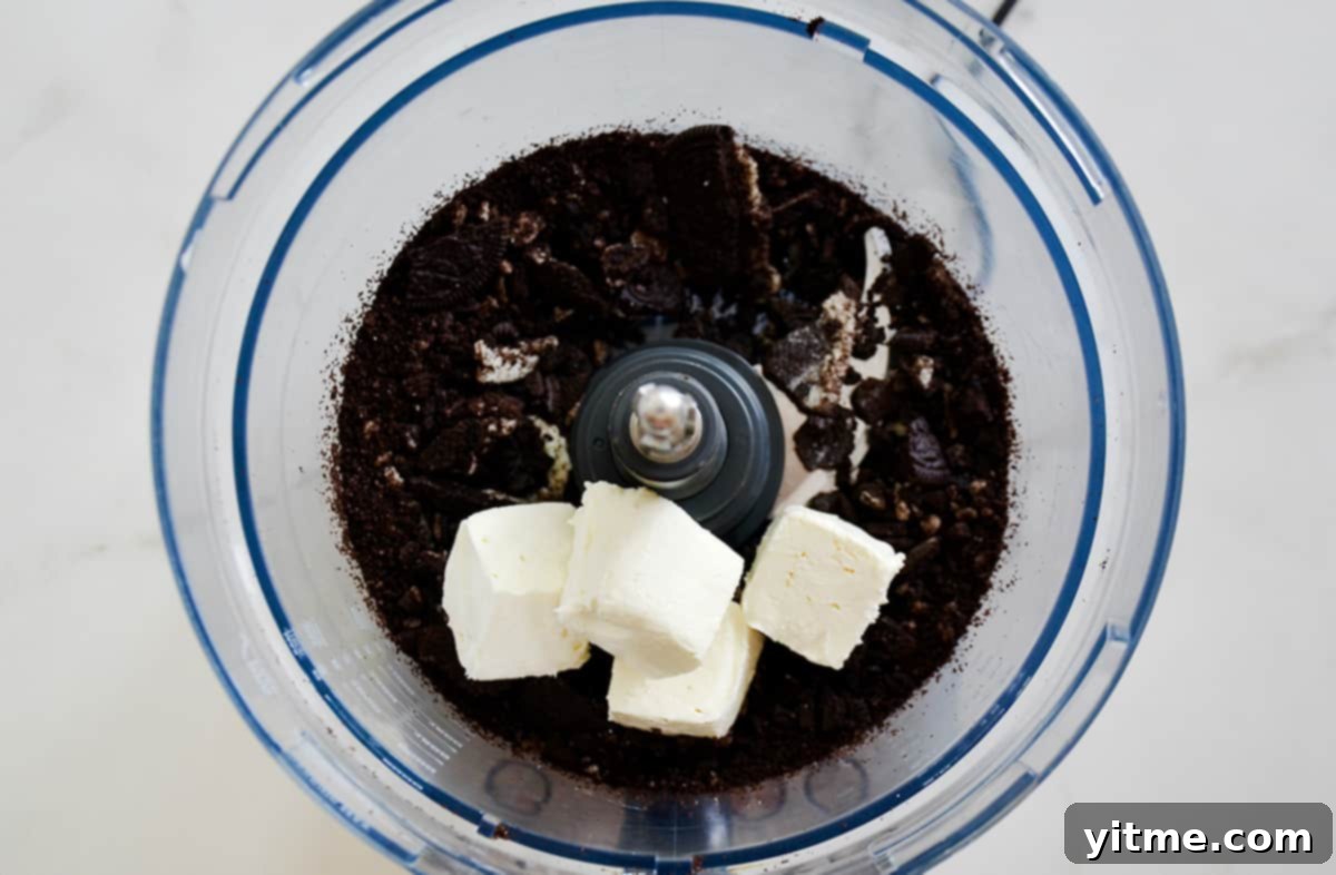Chocolate Cookie Pops: The Easiest Dessert Ever 4 Crushed Oreos and cream cheese in a food processor
