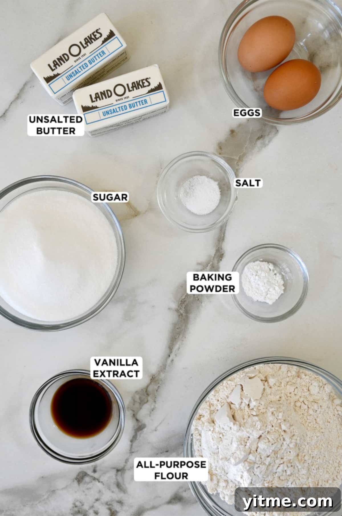 All the essential ingredients for soft sugar cookies: unsalted butter, eggs, salt, baking powder, all-purpose flour, vanilla extract, and granulated sugar.