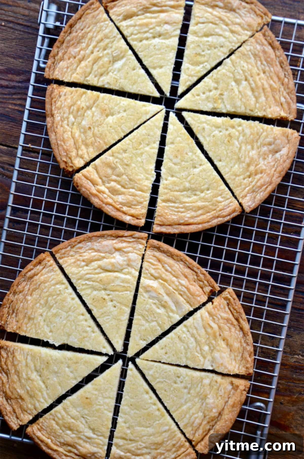 Baked shortbread, cut into wedges, cools on a baking rack.