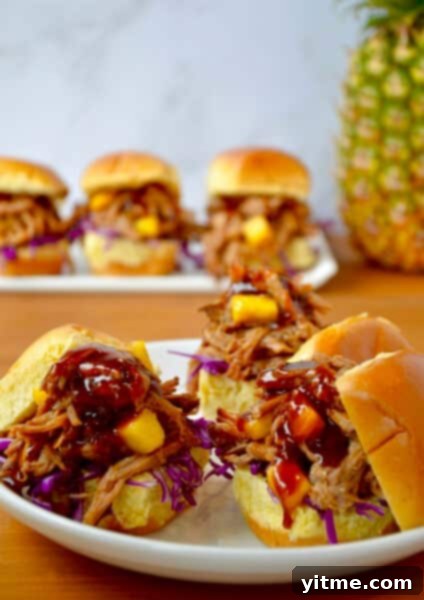 Balsamic Honey Pulled Pork: A Slow Cooker Delight 12 Slow cooker Hawaiian pulled pork with pineapple chunks and barbecue sauce on slider buns.