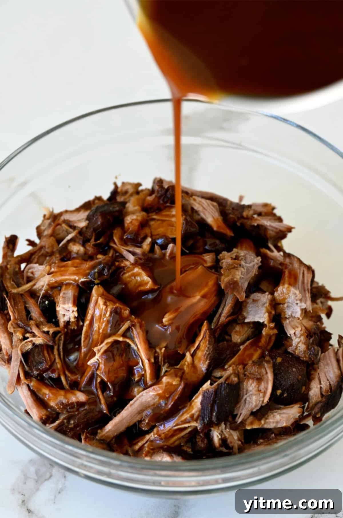 Balsamic Honey Pulled Pork: A Slow Cooker Delight 8 Balsamic glazed pulled pork in a glass bowl.