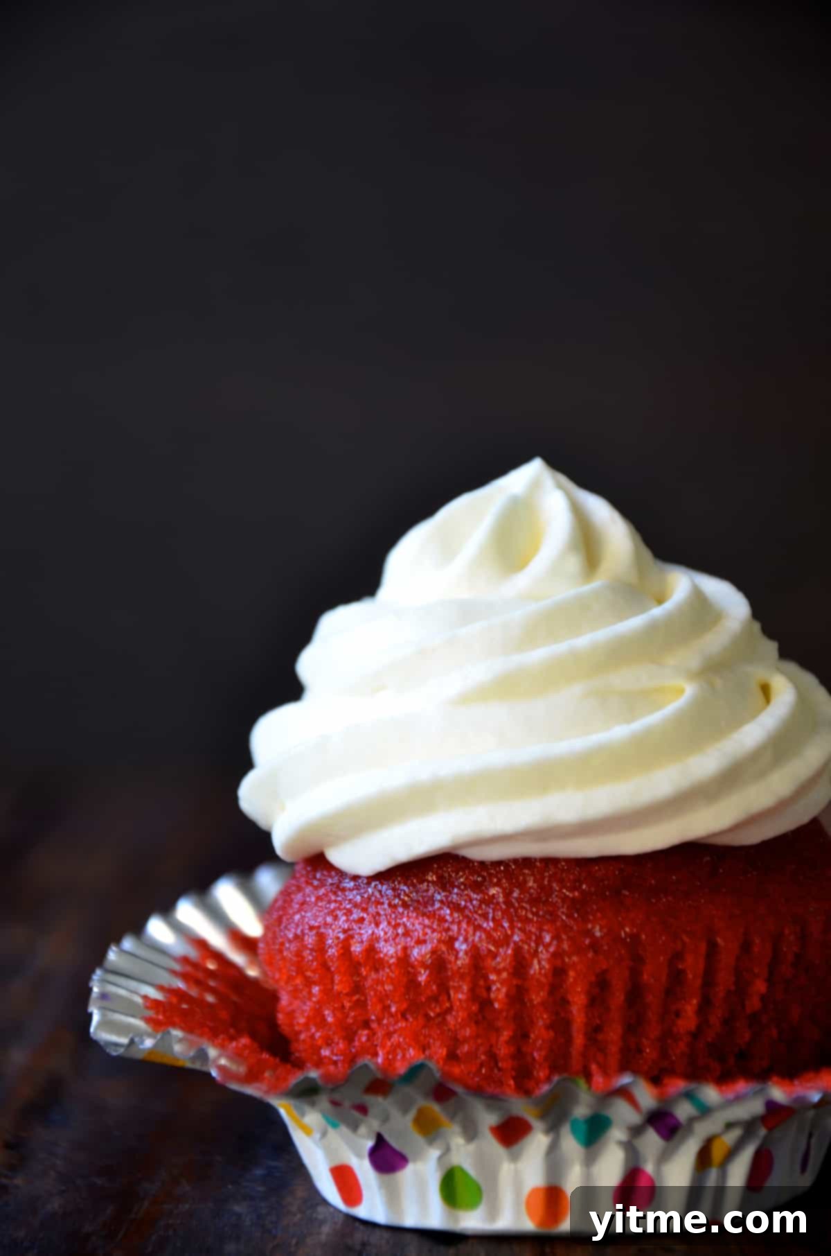 Close-up of a red velvet cupcake with cream cheese frosting