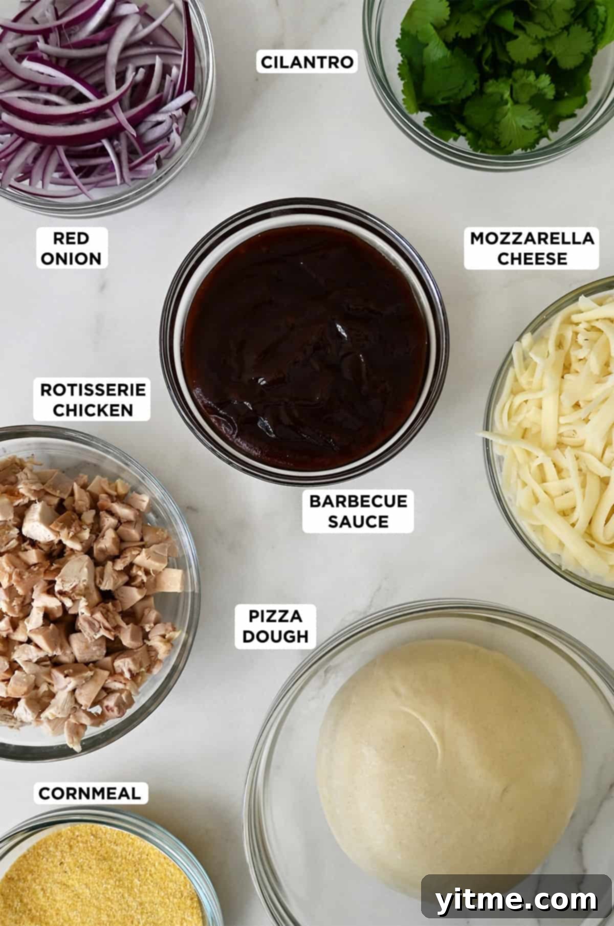 Ingredients for BBQ chicken pizza: pizza dough, shredded chicken, barbecue sauce, sliced red onion, mozzarella cheese, and fresh cilantro.