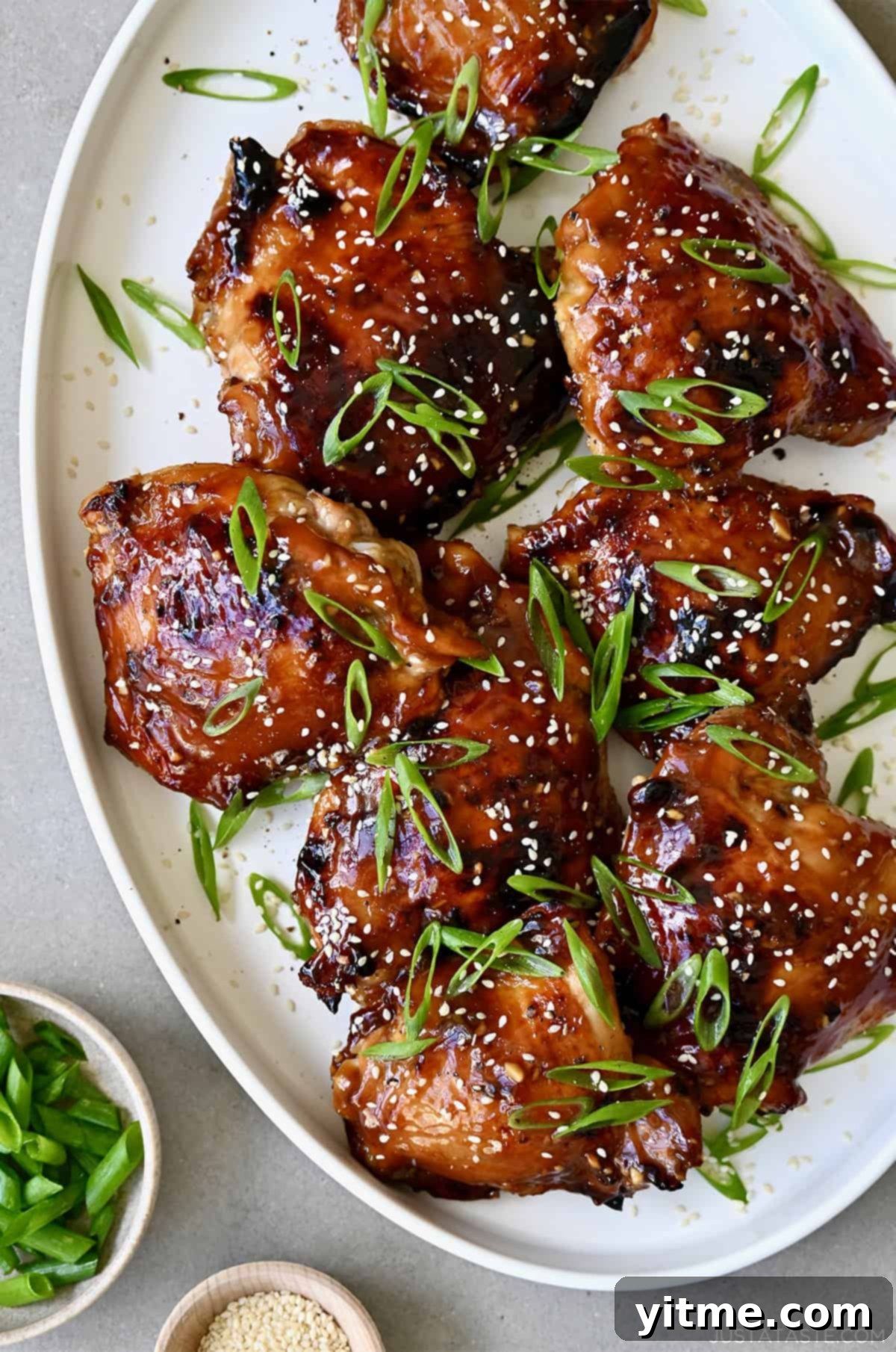Honey Garlic Chicken Thighs: A Flavorful & Easy Weeknight Dinner 2 Honey garlic chicken thighs with sesame seeds and scallions