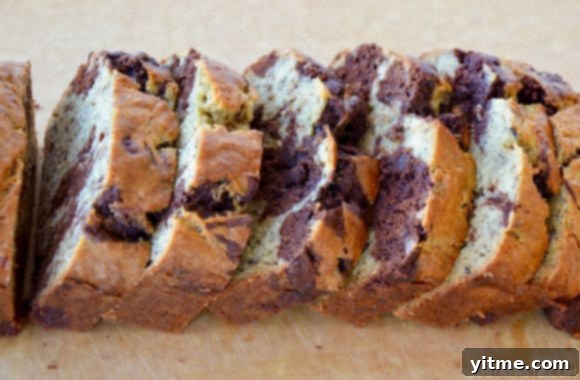 Sliced Chocolate Swirl Banana Bread presented beautifully on a wood cutting board, ready to be served