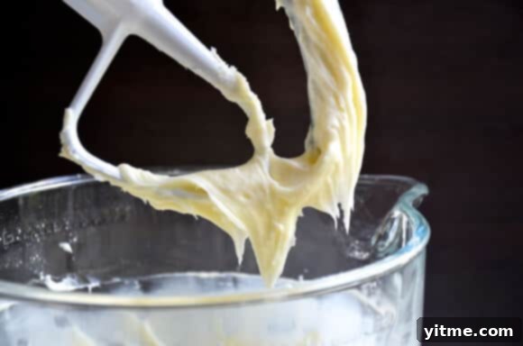 Pineapple Carrot Cake with Cream Cheese Frosting #recipe Kitchen twine outlining carrot shapes on a frosted cake