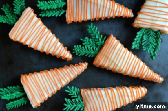Pineapple Carrot Cake with Cream Cheese Frosting #recipe Assortment of decorated Pineapple Carrot Cake slices on a platter