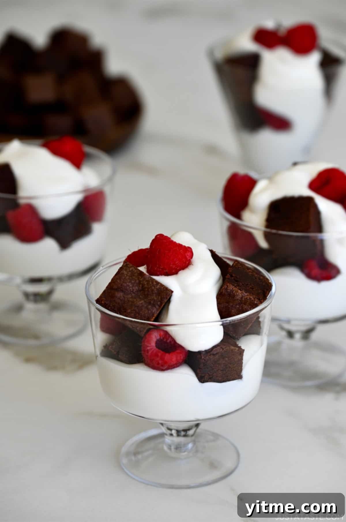 Individual Fruit and Brownie Parfaits 9 Dessert cups filled with whipped cream, brownies, and raspberries