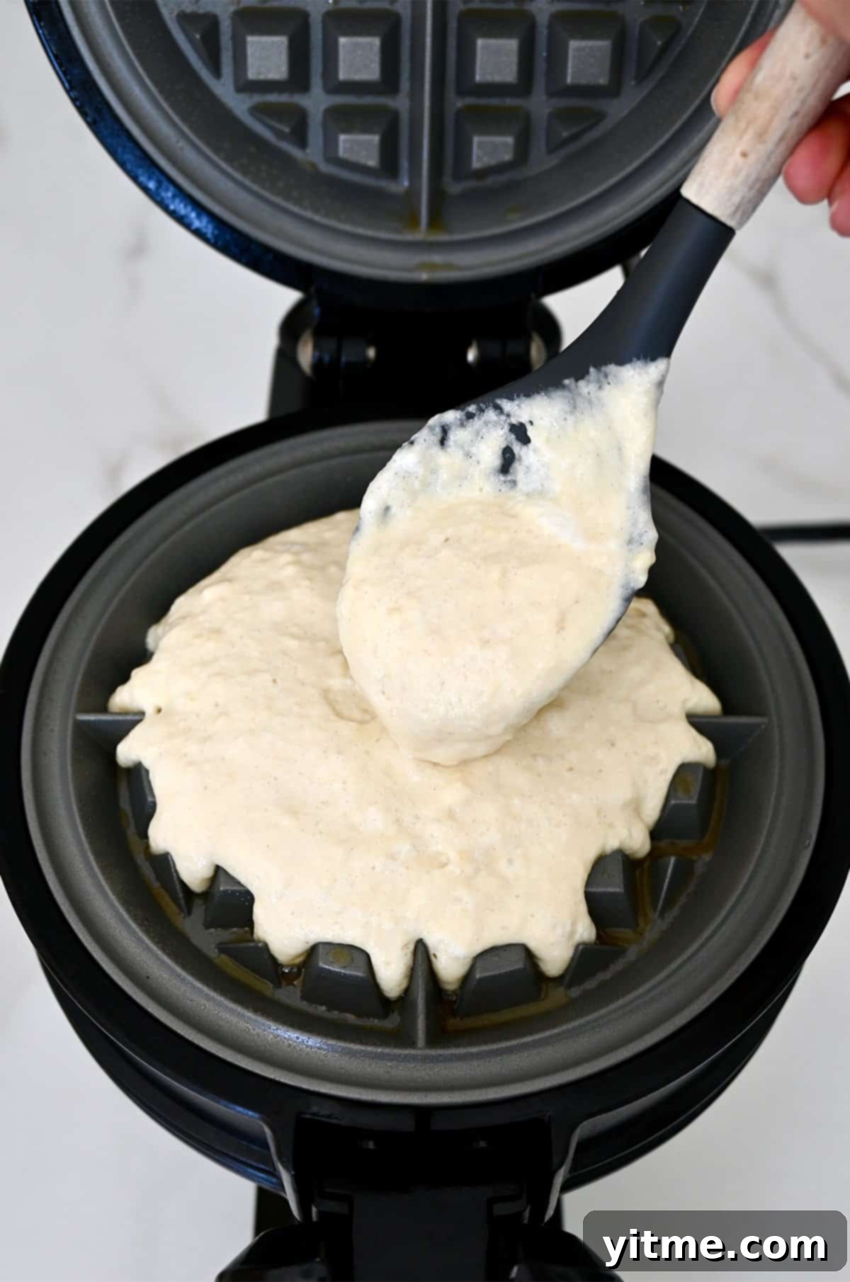 Golden Belgian Waffles From Scratch 10 Adding waffle batter to a preheated and well-greased waffle iron.