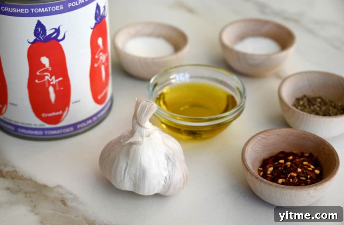 High-quality ingredients for quick marinara sauce: Cento San Marzano crushed tomatoes, fresh garlic, olive oil, and seasonings.