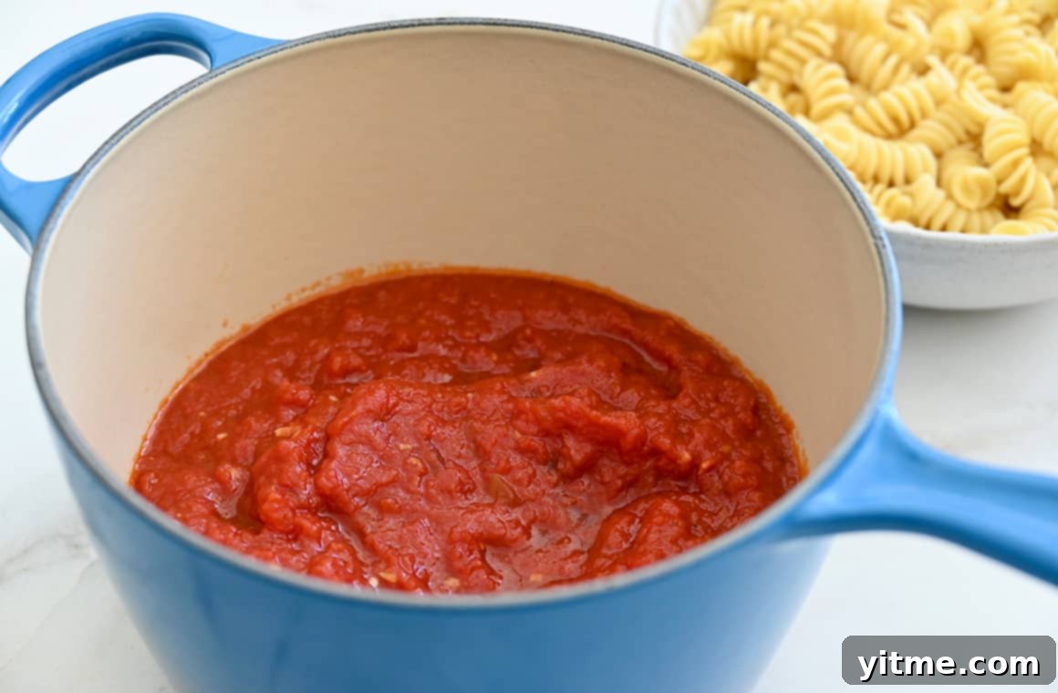 Freshly made quick homemade marinara sauce simmering in a pot, ready for pasta.