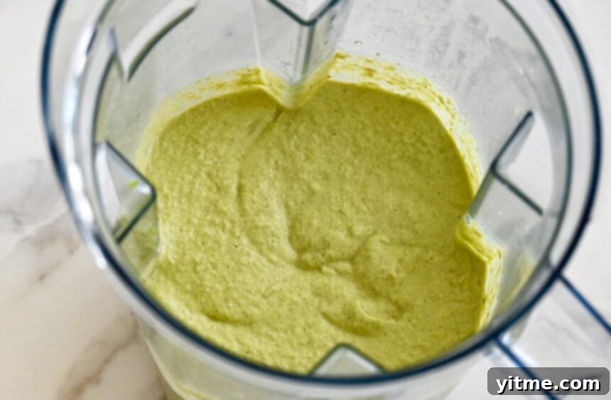 Creamy Asparagus Pesto Pasta 5 Creamy asparagus pesto in a blender, showcasing its smooth and vibrant green texture after blending.