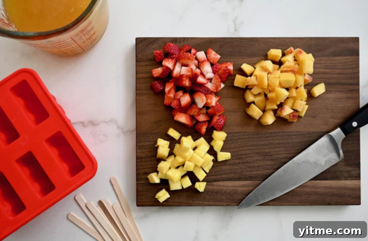 Freshly chopped peaches, strawberries, and pineapple neatly arranged on a rustic wooden cutting board, ready for the sangria popsicle mix.