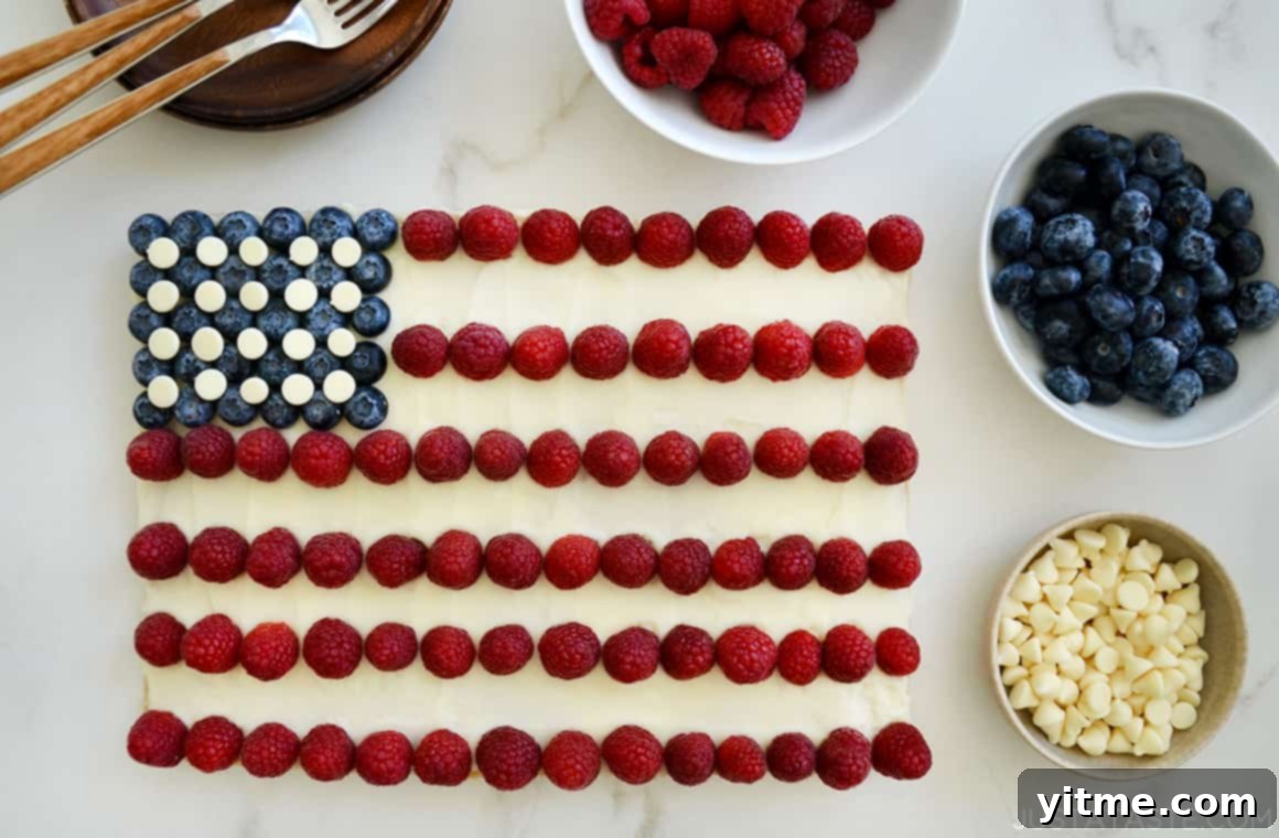 A cookie cake shaped like an American flag with berries