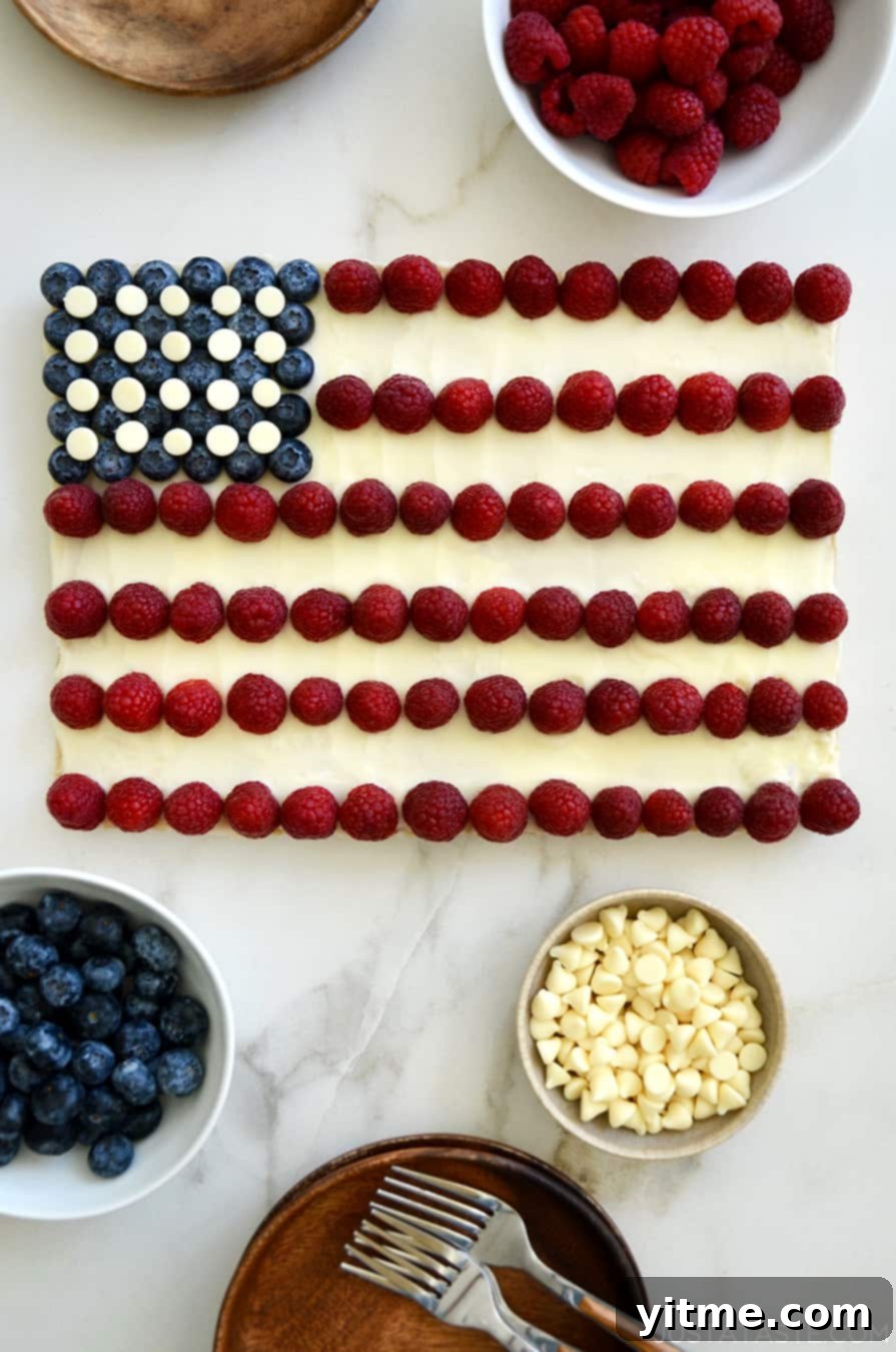 An American Flag Cookie Cake surrounded by bowls of berries