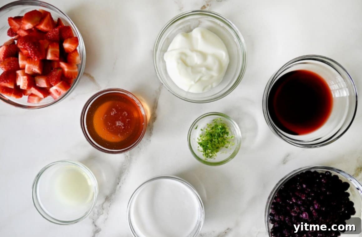 Small glass bowls containing the fresh ingredients to make red, white and blue fruit popsicles
