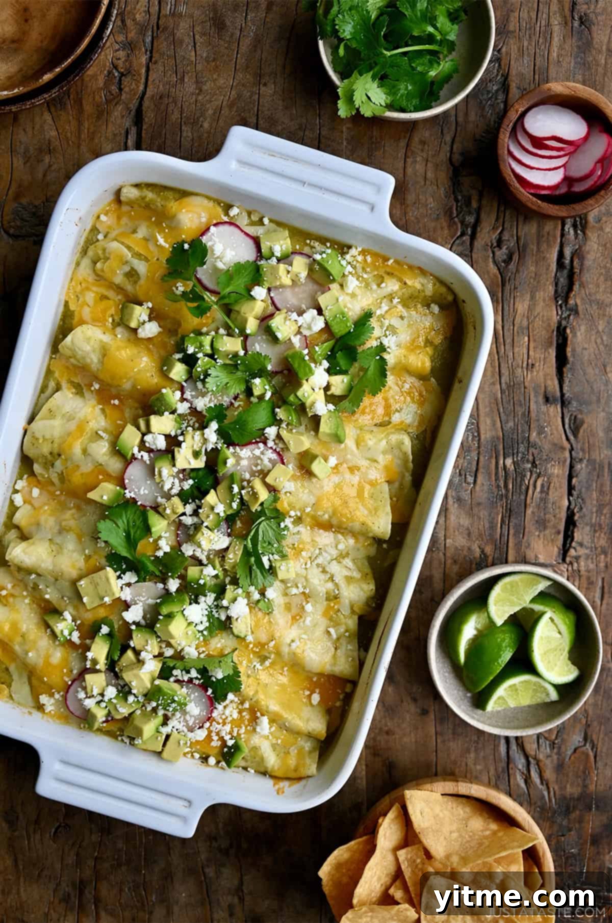 Green chili chicken enchiladas topped with diced avocado, cilantro and sliced radishes.