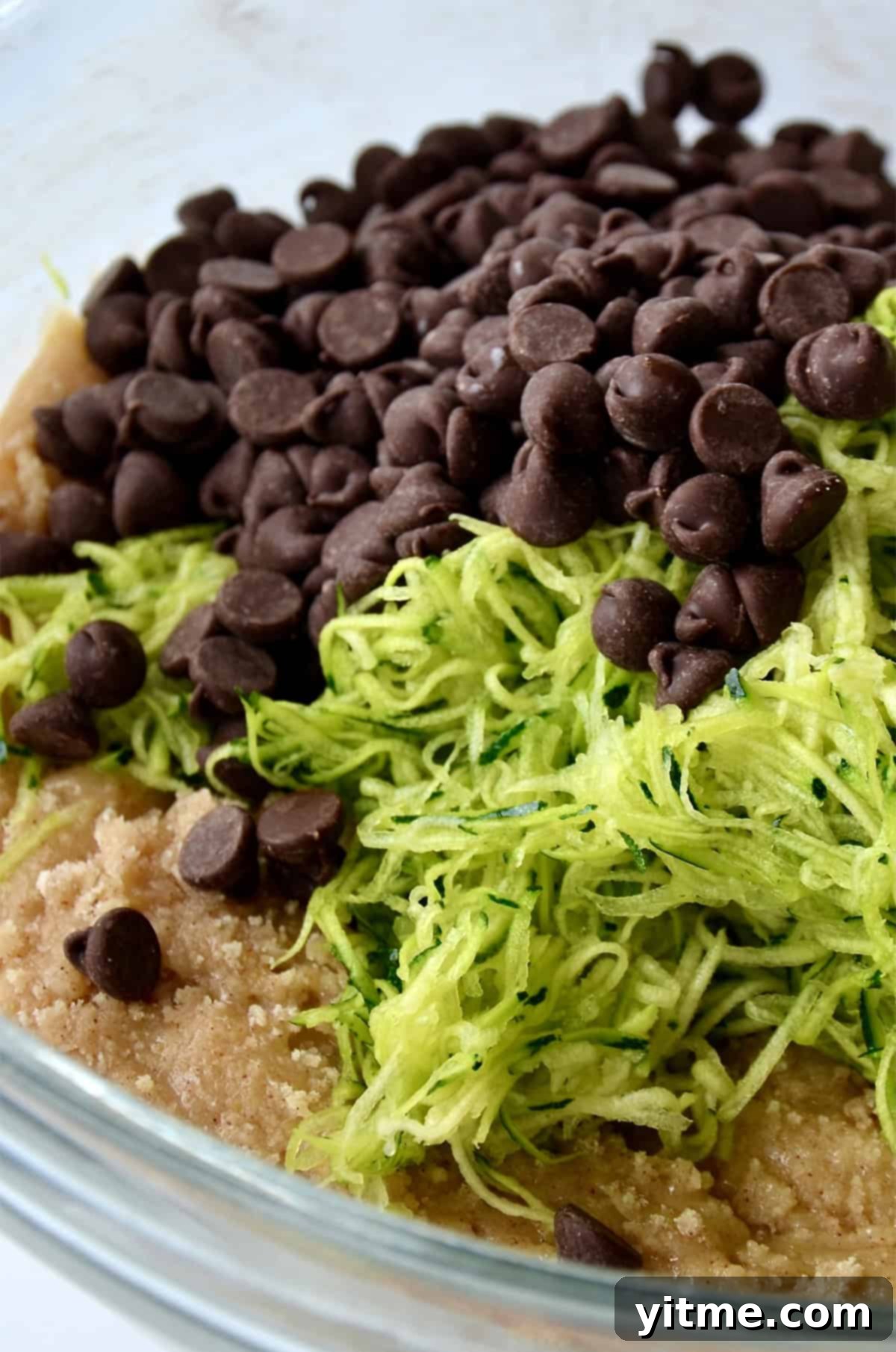 Bread batter topped with finely shredded zucchini and chocolate chips.