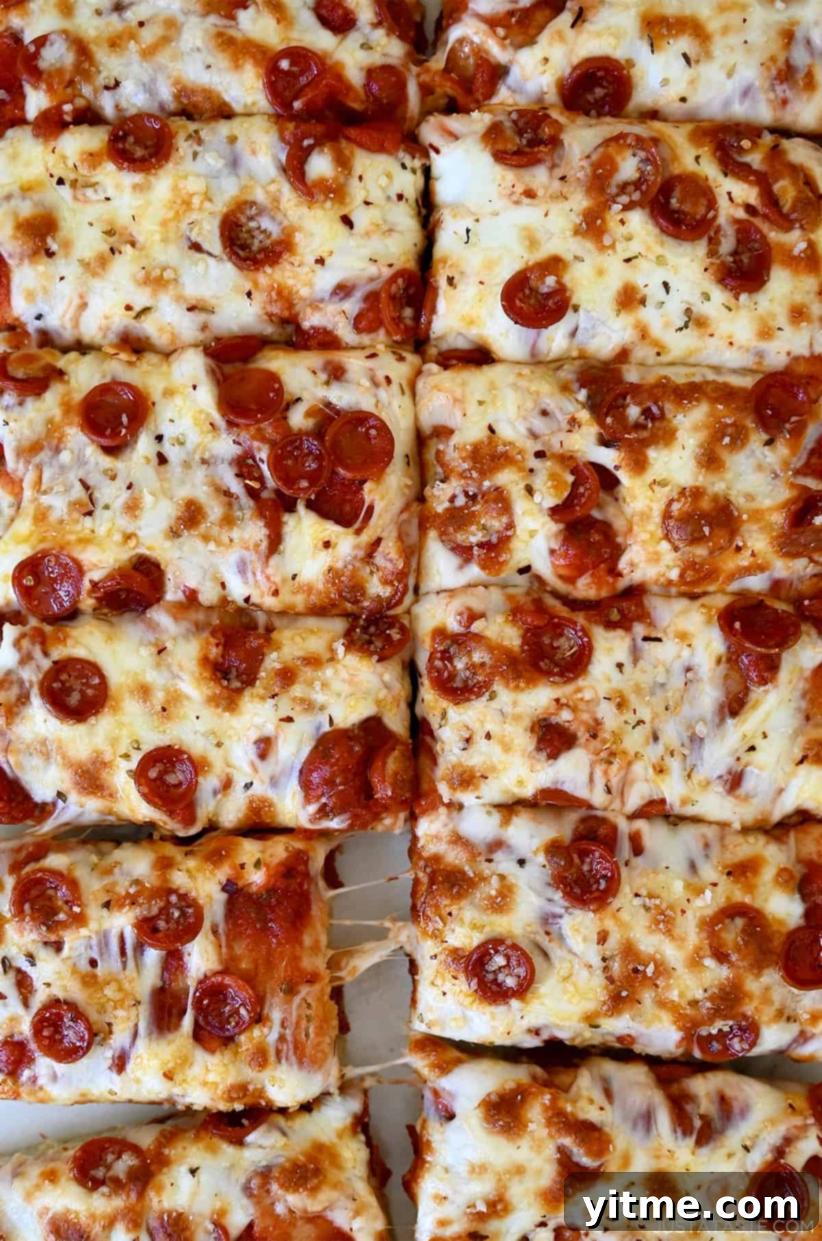 Cheese and pepperoni focaccia pizza cut into slices.
