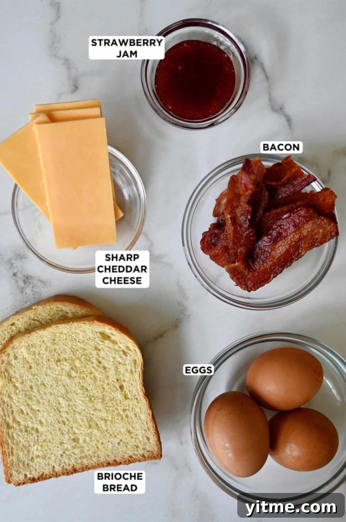 The Quintessential Egg Sandwich 3 Egg sandwich ingredients: bacon, eggs, bread, cheese, and strawberry jam